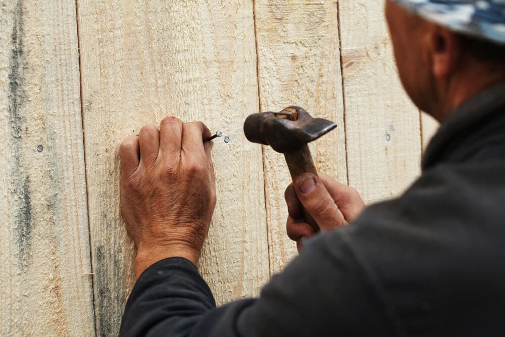 Man nailing a fence - Golden Gate Fences