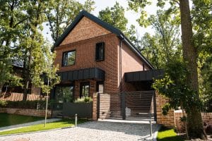 brick house behind a metal fence